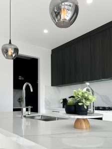 Modern kitchen with grey cabinets and white stone