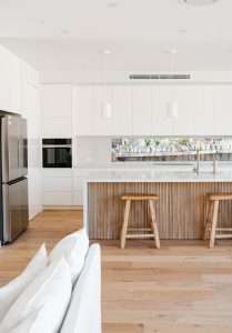 Modern kitchen with wooden flutted island benchtop