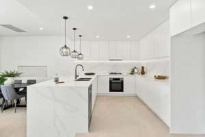 Modern kitchen with finger pull handles and white stone